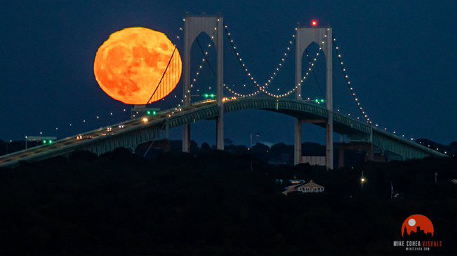 The photo of the harvest moon rising above the Newport Bridge.